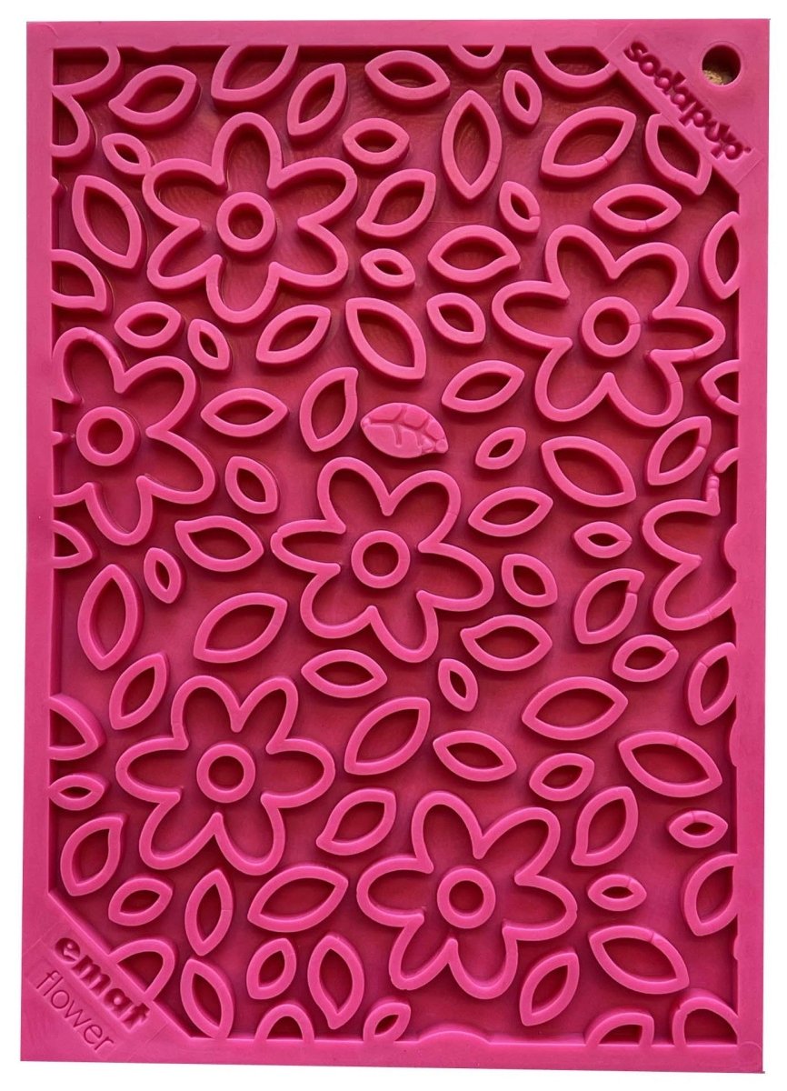 Pink floral silicone mat with flower and leaf cutouts for slow feeding and mental stimulation.