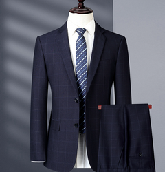 Navy checkered suit jacket with striped tie on a mannequin against a gray background