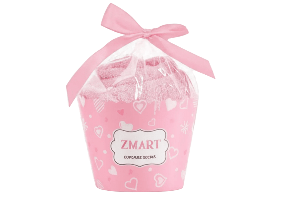 A pair of fluffy pink slipper socks with the text 'THIS Girl IS NOW 10 DOUBLE Digits' and a small birthday cake graphic.