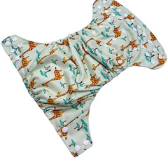 A reusable cloth diaper with a sage green background and an all-over print of orange-brown giraffes and teal birds, shown on a plain white background.