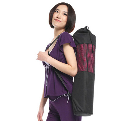 Woman carrying a yoga mat bag.