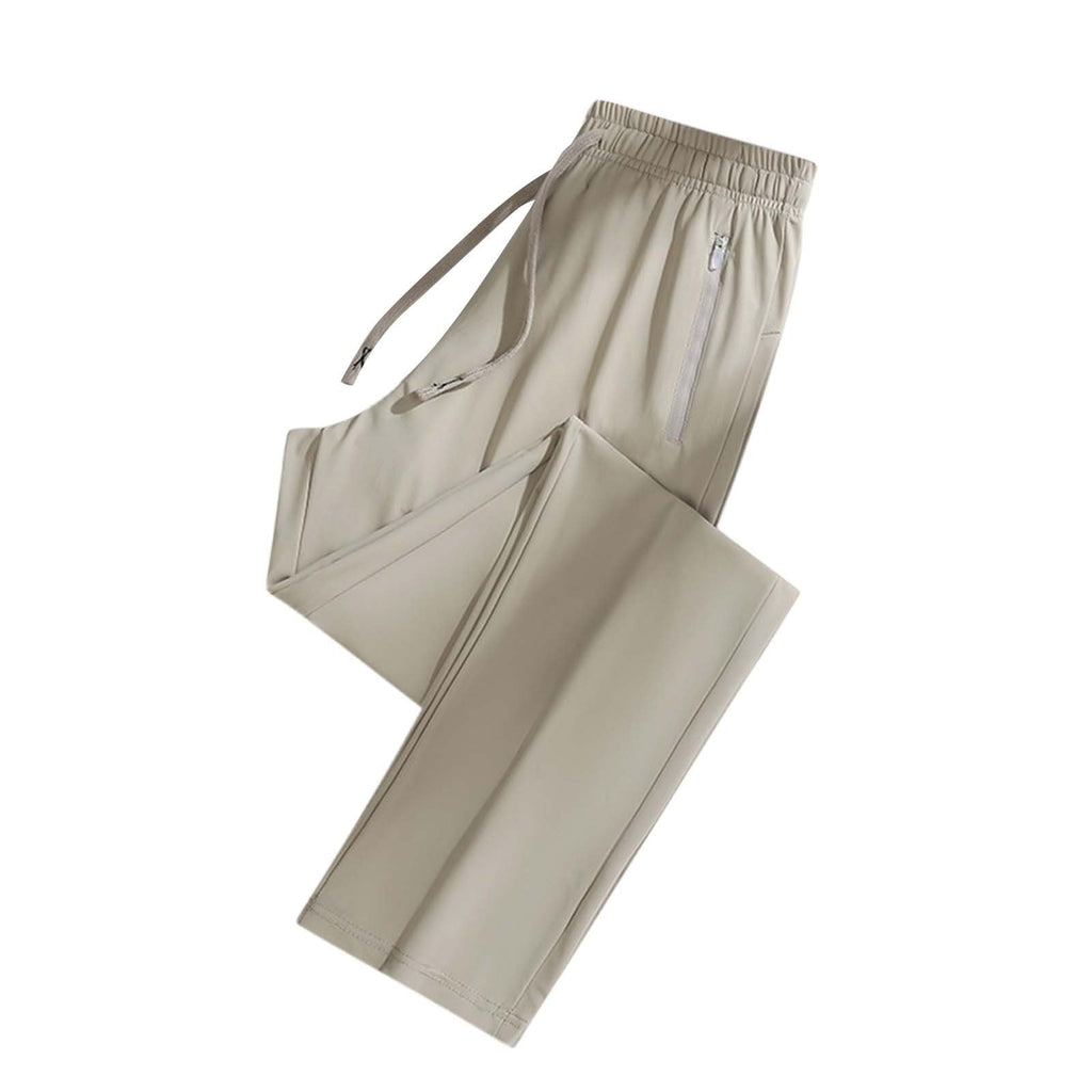 A pair of light beige athletic pants with an elastic waistband, drawstring, and zippered side pocket,