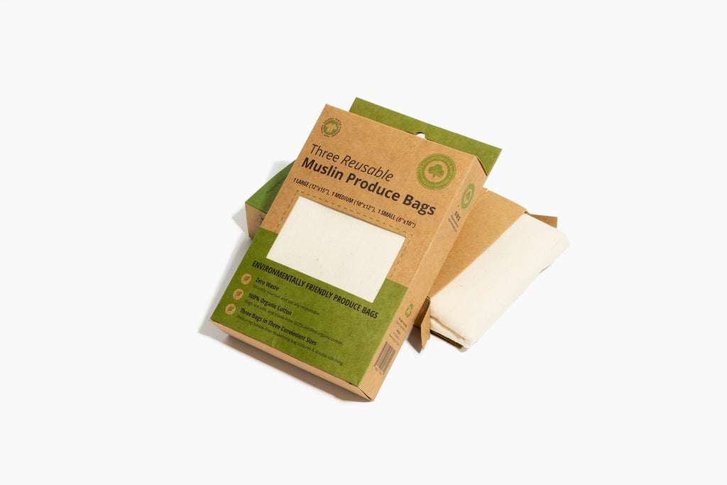 Three reusable muslin produce bags with packaging on a white background